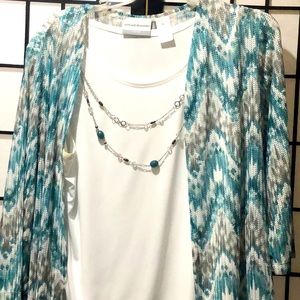 A blouse with an attached necklace .